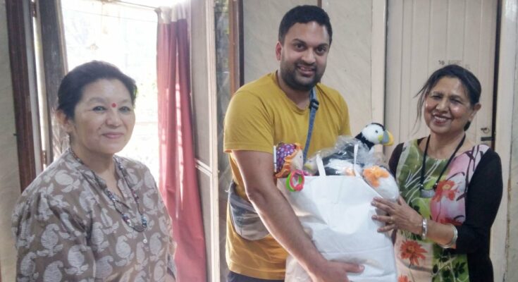 Daniel presenting a gift to the children's home